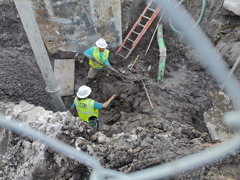 Workers in a trench on a construction site